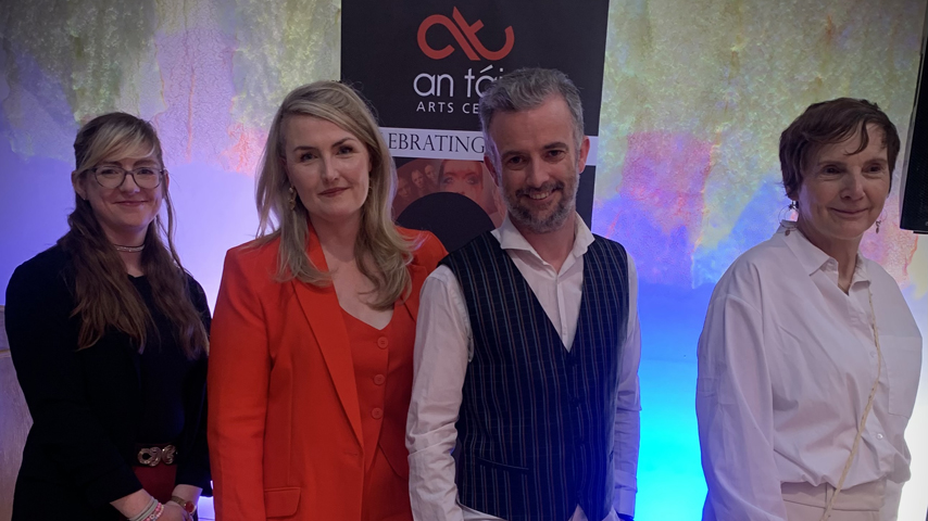 Three women and one man, Linda McConville, Mary Claire Cowley, Paul Hayes and Josie Knight, pose in front of the An Táin Arts Centre 10 year pop up.