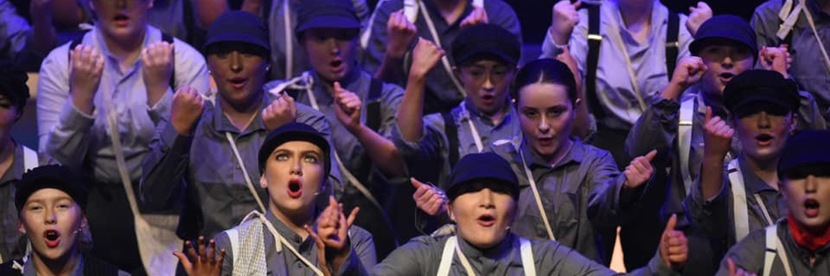 Children dressed in grey caps and coats.